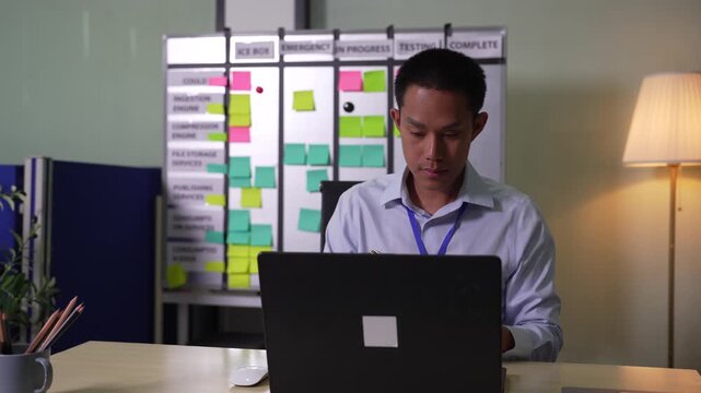 Businessman working on laptop computer with digital document, managing files data, paperless workflow, data search, cloud technology.