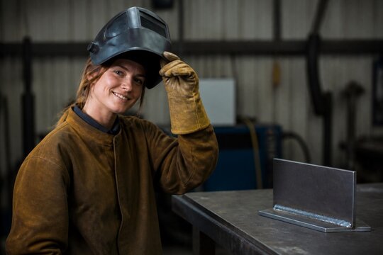 Female welder portrait after completing skilled work
