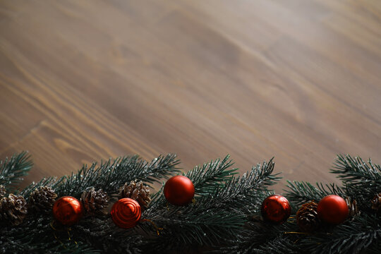 Christmas tree with gift box and decorations on wooden background