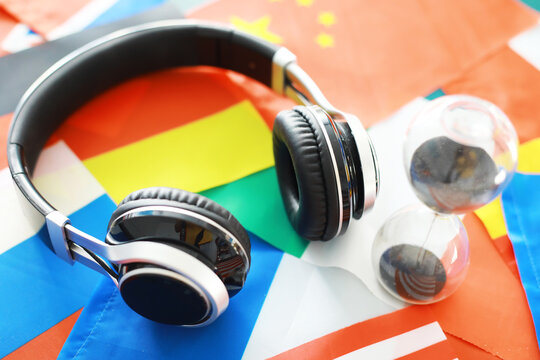 Headphones and flag. The study of foreign subjects. Audiobooks in a foreign language. Language classes. Listening.
