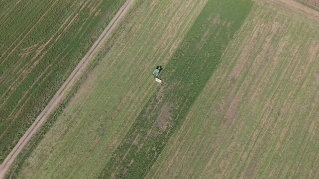Aerial View Tractor Mowing Grass in Agricultural Field in Italy