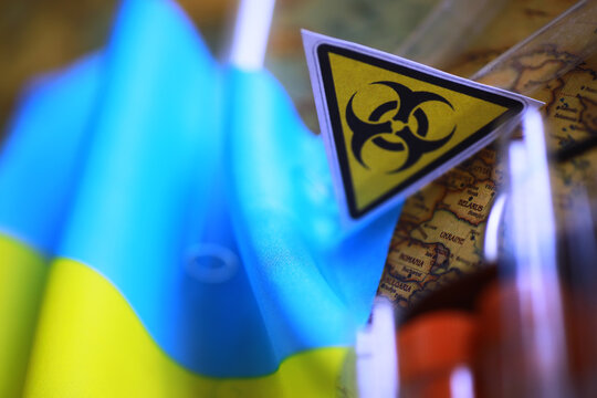Ukrainian flag biohazard and test tubes. Assistance to Ukraine in biolaboratories. Western biological laboratories in Ukraine.