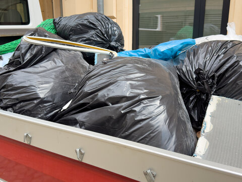 Van Loaded with Waste Bags and Household Refuse After Apartment Clearance &ndash; Waste Disposal and Cleanout Service