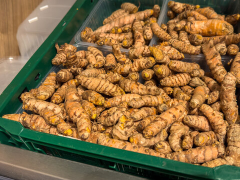 Fresh Organic Turmeric Roots in a Wooden Crate at a Farmers Market &ndash; Natural Food