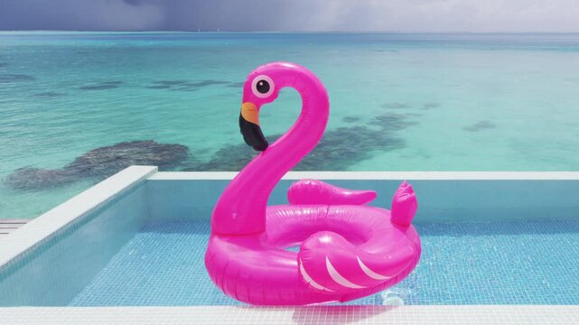 Vacation Travel Pool Beach travel concept with inflatable pink flamingo float toy mattress in luxury swimming pool. Lifestyle summer holidays travel concept perfect background video. Slow motion