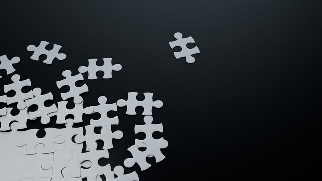 Partially Completed Black and White Jigsaw Puzzle Backdrop with scattered Pieces. Work in Progress Concept with copy-space.