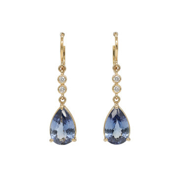 Pair of gold drop earrings featuring teardrop shaped blue tanzanite gemstones and small round diamond accents isolated on a transparent background