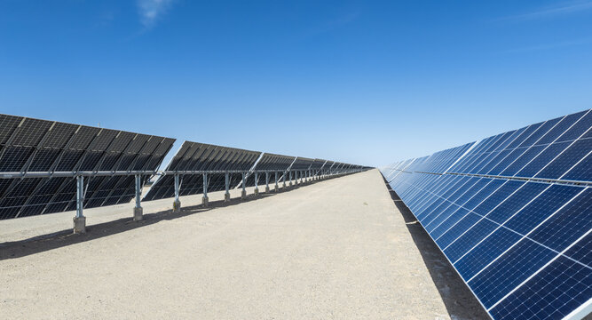 Close-up Solar Panels With Automatic Tracking Mounts on Desert Terrain