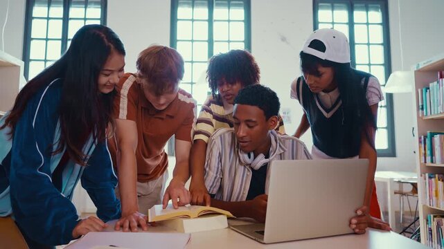 Multiethnic students group smiling chatting inside library
