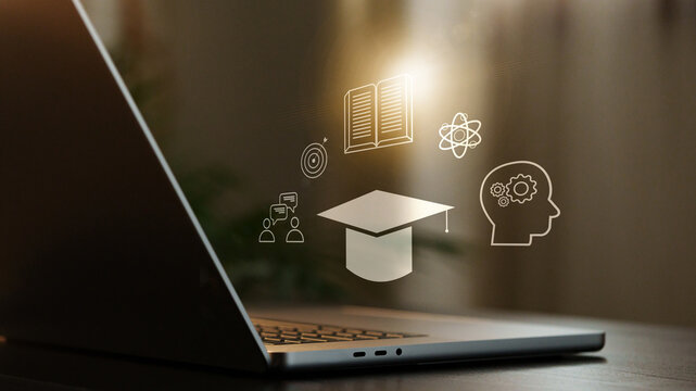 E learning concepts displayed on a laptop screen with various educational icons in a study space during daytime