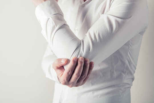 Man suffering from pain in elbow. Pain in the elbow joint.