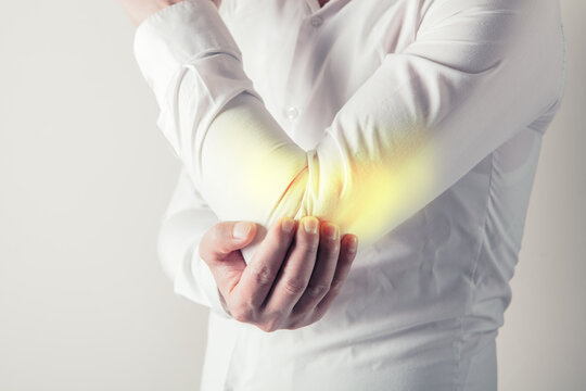 Man suffering from pain in elbow. Pain in the elbow joint.