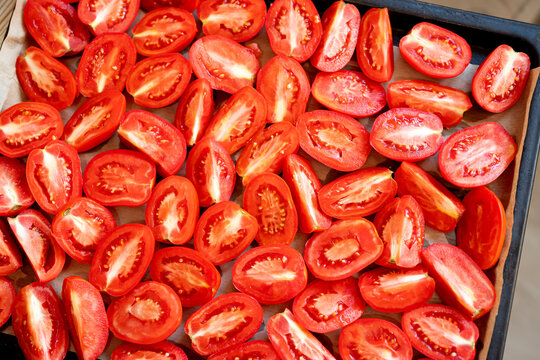 Red halved tomatoes as background