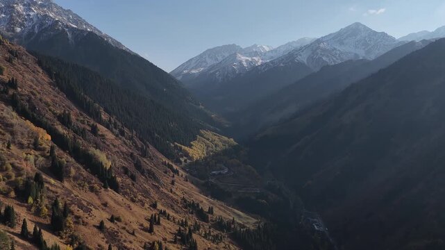 Aerial view flying through a deep mountain valley in autumn, Kazakhstan