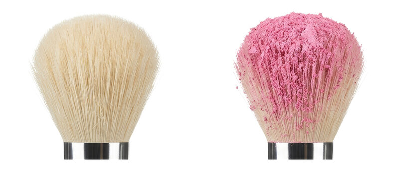 Professional cosmetic makeup brushes with soft bristles and pink powder for application