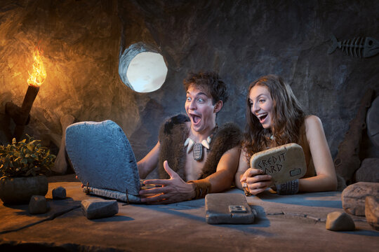 Prehistoric Couple Amazed by Online Shopping Deal