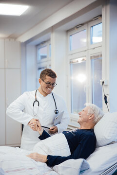 Doctor and patient smiling together in hospital healthcare setting