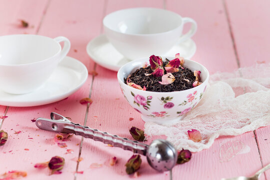 Bowl of black tea with dried rose blossoms