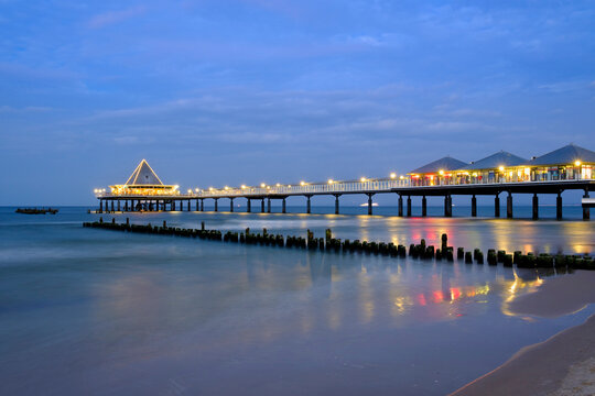 Germany, Usedom, Heringsdorf, remains of the old and new pier in the evening