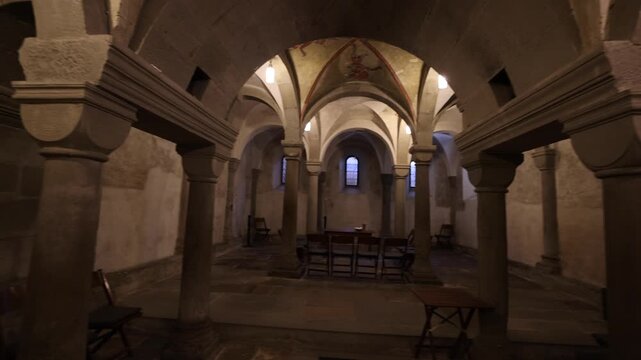 View of the Romanesque crypt with stone columns and vaulted ceilings inside the historic Grossmunster in Zurich, Zurich, Switzerland.