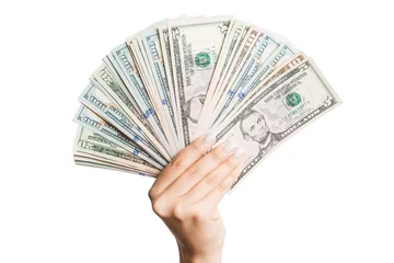 Top view of isolated female hand holding a fan of different dollar bills. Wealth and rich concept © sosiukin