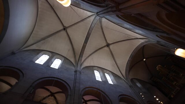 View of the historic vaulted ceiling and arched windows inside the Grossmunster church in Zurich, Zurich, Switzerland.