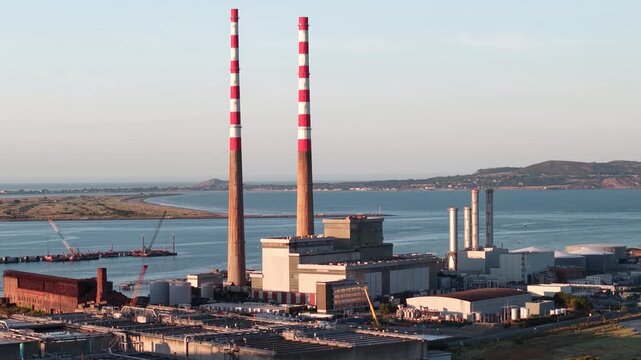 Beautiful drone scene of Poolbeg Industrial Estate on Dublin coast with Howth background.
