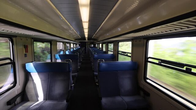 View of the modern interior of the Gotthard Panorama Express train with empty seats and motion blur visible through the windows in Lugano, Ticino, Switzerland.