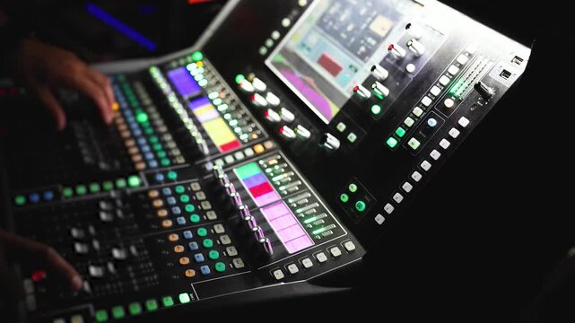 Sound engineer operator working on mixing console workplace during live event concert on stage show broadcast, light mixer controller panel, lighting technician workplace with professional equipment