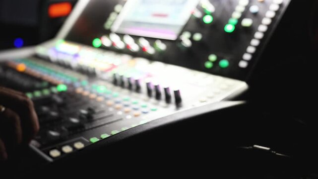 Sound engineer operator working on mixing console workplace during live event concert on stage show broadcast, light mixer controller panel, lighting technician workplace with professional equipment