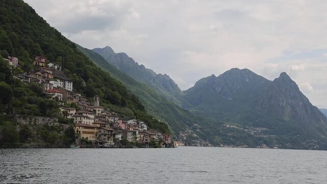 View of the historic village of Gandria nestled on the slopes of Mount Bre overlooking Lake Lugano with traditional stone architecture in Lugano, Ticino, Switzerland.