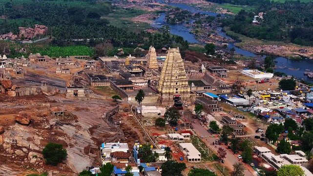 Aerial view of virupaksha temple and hampi market, with tunghabhadra river flowing in background, hampi, karnataka, india.