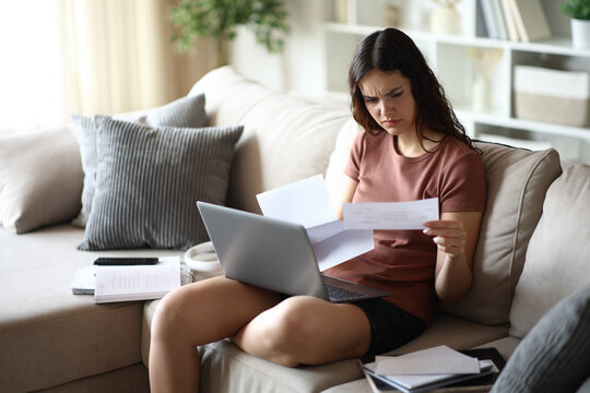 Frustrated student reading strange letter at home
