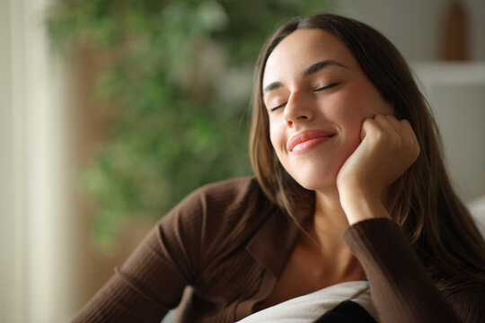 Satisfied woman relaxing leaning on a couch