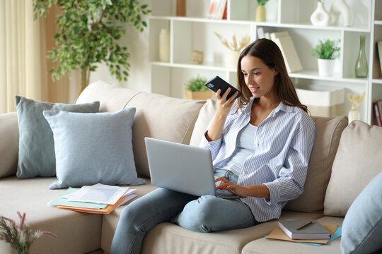 Telecommuter using ai dictating on phone working at home