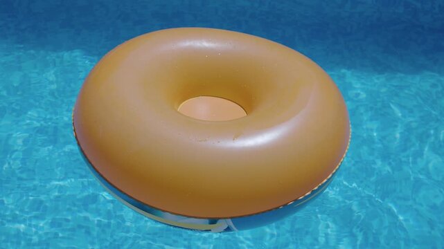 Orange inflatable ring floating on clear water in swimming pool
