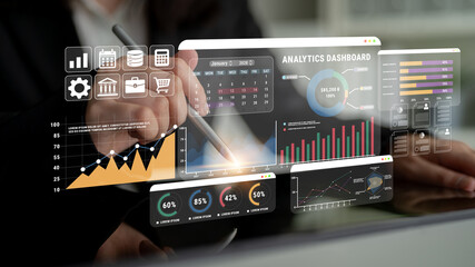 Professional using digital analytics dashboard with graphs, charts, and data visuals for business...
