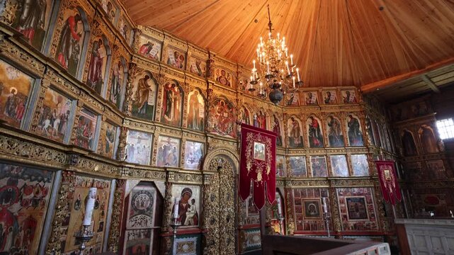View of the ornate iconostasis inside the Kizhi church with intricate gold carvings and religious paintings in Petrozavodsk, Republic of Karelia, Russia.