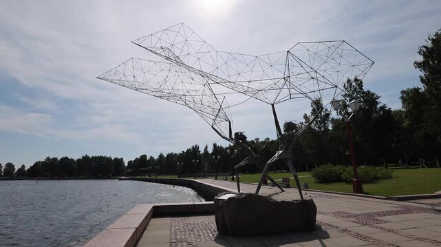 View of the wire-frame Fishermen sculpture on the Onega Lake embankment in Petrozavodsk, Republic of Karelia, Russia.