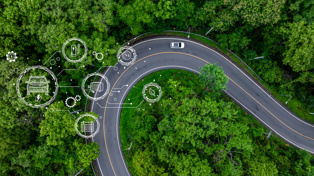 Electric vehicle or EV electrical energy for environment on forest road, Sustainable energy transportation, Electric car and EV electric energy for environment.