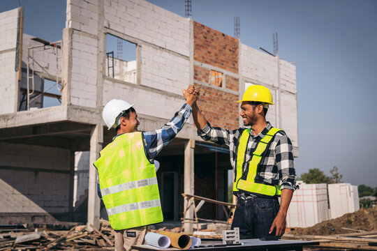 Adult Asian Engineers Celebrating Construction Project Success w