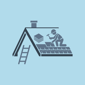 Worker installing roof shingles on a house roof.