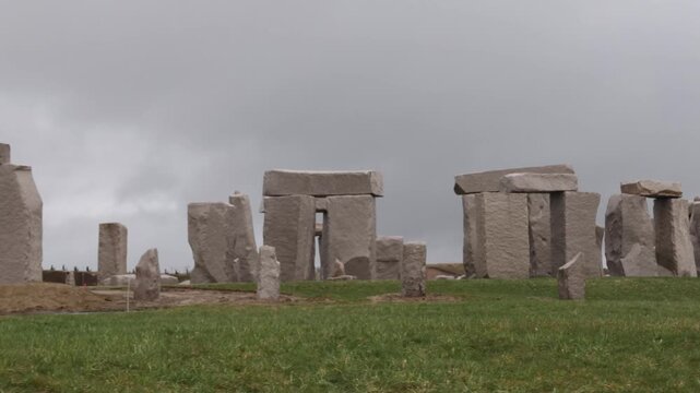 View of stone monoliths arranged in a circle on a grassy field at the Hill of the Buddha in Sapporo, Hokkaido, Japan.