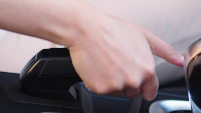 Close Up of Hand Shifting Gear and Releasing Handbrake in Modern Car Interior, Driver Operating Vehicle Controls Before Driving Footage, Automotive Transmission and Parking Brake Concept, Car Interior