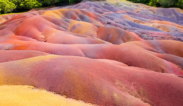 Chamarel Seven Colored Earth Geopark in Mauritius Island. Colorful panoramic landscape about this volcanic geological formation Chamarel Seven Colored Earth Geopark in Riviere noire district.