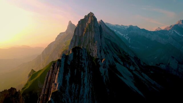 Cinematic drone shot flying over mountain range Grindelwald valley in Switzerland Bernese Alps. Aerial view Sharp Granite Spires and Rugged Slopes of High Mountains. rock stone peak. landscape nature