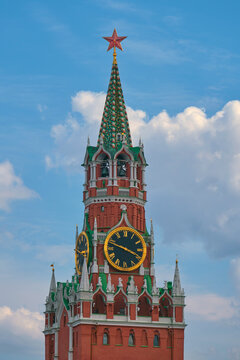 Historic clock tower Spasskaya Tower with star spire against blue sky. Iconic Russian architecture and Moscow landmark representing history, tourism, travel, and cultural heritage.