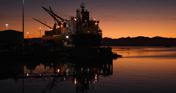 View of sunset over the harbor in Nelson, Nelson Region, New Zealand.