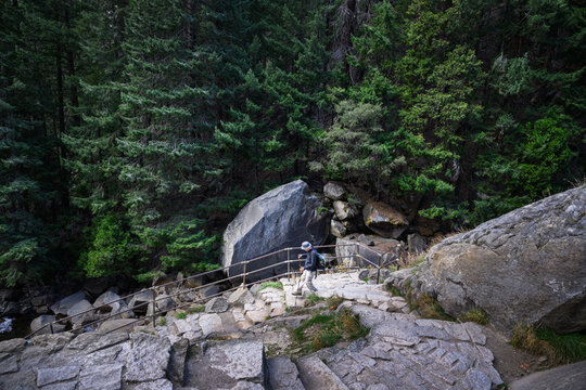 Hiker walking down steep switchback from Vernal Fall. Mist Trail at Yosemite National Park. California. USA.