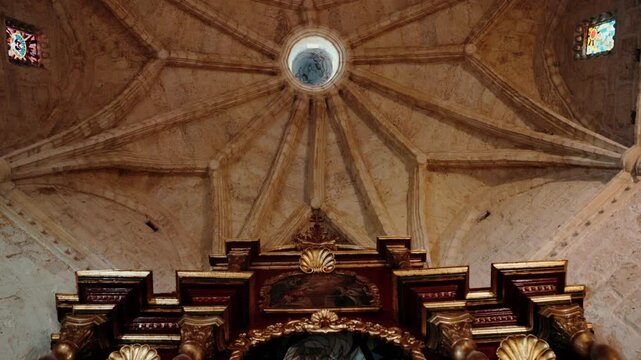View of the ornate golden altar and ribbed vaulted ceiling inside the historic Catedral Castrense de Santa Barbara in Santo Domingo, Distrito Nacional, Dominican Republic.